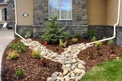 Dry Stream Rock Bed from Drainspout and Mulch Bed with Various plants