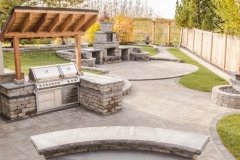 Barkman Stone Oasis Curved bar and BBQ area and fireplace