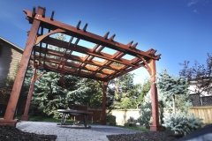 stained cedar pergola with decorative double beams