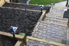 borders - 4 x 6 pressure treated retaining wall with black mulch bed and double mow brick border