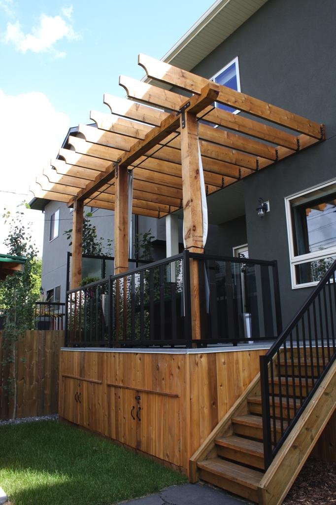 decks - Cedar pergola over vinyl deck finished with cedar tounge and groove skirting
