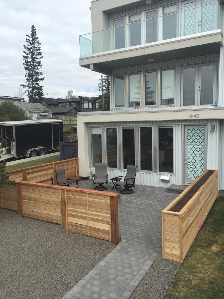 Fences - decorative horizontal slat cedar fence around a front yard patio with custom built in planter box