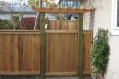 Fences - decorative cedar arbor and gate with friendly neighbour style fence with pressure treated posts