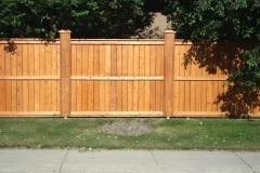 Fences - Stained cedar fortress style fence with post caps