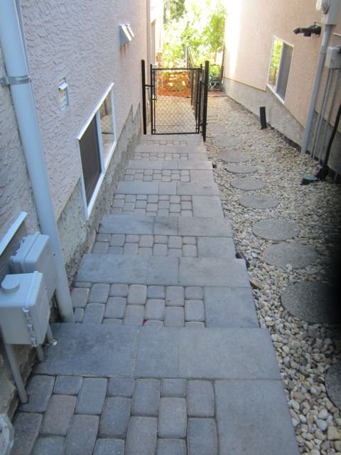 Side steps built with Pisa II and Capstone risers and rustic cobble pavers