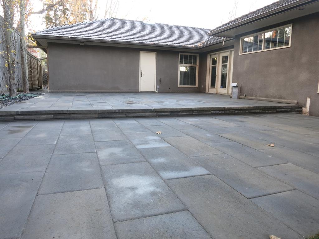 Patio - Rinox Proma 60mm tile paving ston with Solino retaining step and capstone