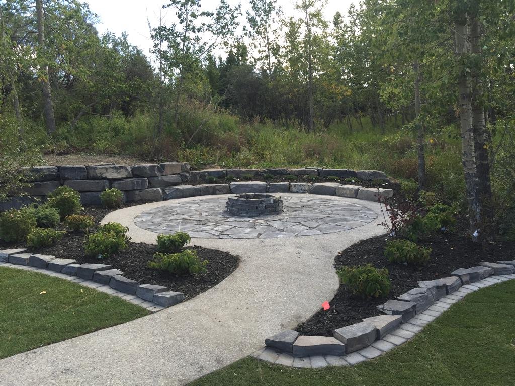 Patio - Mow brick backed up by rundle stone border with exposed aggregate pathway and rundle flagstone patio and rundle dry stack firepit