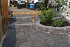 patio - Rundle Flagstone Patio with Roman Stackstone decorative walls in Charcoal
