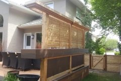 Horizontal cedar privacy screen added to the existing deck.