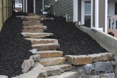 steps - ironstone slab steps and retaining wall with black mulch beds